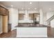This spacious kitchen features stainless appliances, island with sink, and modern fixtures at 21295 E 61St Dr, Aurora, CO 80019