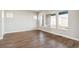 Bright living room featuring wood floors, recessed lighting, and a large window at 21295 E 61St Dr, Aurora, CO 80019