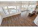 Open-concept living space with hardwood floors, modern fixtures, and large windows with backyard views at 21295 E 61St Dr, Aurora, CO 80019