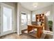 Stylish office with a wood desk, built-in shelving, a bright window, and a modern aesthetic at 21295 E 61St Dr, Aurora, CO 80019