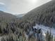 A wooded and mountainous landscape surrounds this cabin, offering a secluded and scenic retreat at 379 Rainbow Rd, Idaho Springs, CO 80452