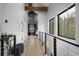 Hallway with hardwood floors and staircase with metal and wood railing at 379 Rainbow Rd, Idaho Springs, CO 80452