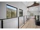 Hallway with hardwood floors, cable railing, and scenic view out of large window at 379 Rainbow Rd, Idaho Springs, CO 80452