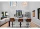 Bright, open kitchen features white cabinets, a marble island, and modern appliances at 379 Rainbow Rd, Idaho Springs, CO 80452