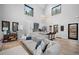 Bright, open-concept living room, kitchen and dining with vaulted ceilings and forest views at 379 Rainbow Rd, Idaho Springs, CO 80452