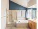 This bathroom boasts a separate shower and luxurious soaking tub below a large window, offering a spa-like experience at 7158 W Belmont Dr, Littleton, CO 80123
