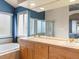 Bathroom featuring dual sinks with ample counter space, perfect for a shared, functional and bright space at 7158 W Belmont Dr, Littleton, CO 80123