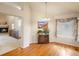 Elegant dining area featuring wood floors, a chandelier, and seamless access to the living room at 7158 W Belmont Dr, Littleton, CO 80123