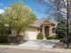 Charming single-Gathering home with a well-manicured front yard, attached garage, and stone and siding accents at 7158 W Belmont Dr, Littleton, CO 80123