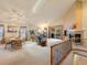 Spacious living room featuring a fireplace, vaulted ceilings, a skylight, and access to the patio at 7158 W Belmont Dr, Littleton, CO 80123