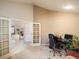 Comfortable home office space with carpet, a large desk, and views of the living room at 7158 W Belmont Dr, Littleton, CO 80123