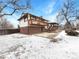Backyard with wooden deck in the snow and ample space, great for outdoor entertaining at 1394 E Panama Dr, Centennial, CO 80121
