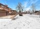 Expansive backyard covered in snow with patio area at 1394 E Panama Dr, Centennial, CO 80121