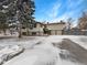 Charming two-story home featuring a driveway and a well-maintained lawn with mature trees under a partly cloudy sky at 1394 E Panama Dr, Centennial, CO 80121