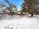 Exterior view of a home with a snow-covered front yard at 1394 E Panama Dr, Centennial, CO 80121