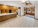 Spacious kitchen featuring wood cabinets, tile flooring, and a sunroom at 1394 E Panama Dr, Centennial, CO 80121