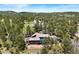 Aerial view of a spacious home with a pool surrounded by lush greenery at 2851 Interlocken Dr, Evergreen, CO 80439