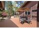 Relaxing backyard deck with outdoor dining area, large umbrella and views of pond and gazebo at 2851 Interlocken Dr, Evergreen, CO 80439