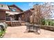 Inviting back patio with stone flooring, seating, and a view of flowering trees at 2851 Interlocken Dr, Evergreen, CO 80439