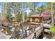 Backyard pond with a charming gazebo, surrounded by trees and rocks at 2851 Interlocken Dr, Evergreen, CO 80439