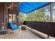 Relaxing balcony with comfortable seating and views of surrounding trees at 2851 Interlocken Dr, Evergreen, CO 80439