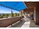 Spacious balcony with awning cover, outdoor seating, and expansive mountain views at 2851 Interlocken Dr, Evergreen, CO 80439