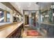 Modern bathroom featuring a glass-enclosed shower, a double vanity, and natural light, offering a spa-like experience at 2851 Interlocken Dr, Evergreen, CO 80439