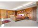 Cozy bedroom with wood-paneled walls, a comfortable bed, and unique design elements creating a warm atmosphere at 2851 Interlocken Dr, Evergreen, CO 80439