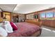 Cozy bedroom with wood-paneled walls, a comfortable bed, and unique design elements creating a warm atmosphere at 2851 Interlocken Dr, Evergreen, CO 80439