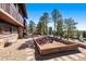 Well-maintained bocce ball court nestled in a gravel surround and stone hardscape. It abuts the structure's exterior at 2851 Interlocken Dr, Evergreen, CO 80439
