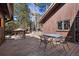 Deck offers great views of the surrounding forest and features a table with chairs for outdoor dining at 2851 Interlocken Dr, Evergreen, CO 80439