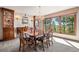 Elegant dining room with a chandelier, ample natural light, and views of the surrounding trees at 2851 Interlocken Dr, Evergreen, CO 80439