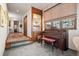 Inviting entryway featuring a piano, built-in display cabinet, and neutral-toned decor at 2851 Interlocken Dr, Evergreen, CO 80439