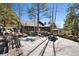 Charming home nestled amidst trees and landscaping, featuring a fire pit area for outdoor enjoyment at 2851 Interlocken Dr, Evergreen, CO 80439