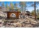 Picturesque home surrounded by trees, showcasing a gazebo and a stone patio for relaxation and enjoyment at 2851 Interlocken Dr, Evergreen, CO 80439