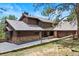 Beautiful exterior of home with stone accents, a covered entrance, and attached garage at 2851 Interlocken Dr, Evergreen, CO 80439