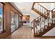 Inviting foyer with tile flooring, a wooden staircase, and access to a sunroom, showcasing the home's layout at 2851 Interlocken Dr, Evergreen, CO 80439