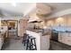 Spacious eat-in kitchen with bright cabinetry, island with bar seating, and carpeted floors at 2851 Interlocken Dr, Evergreen, CO 80439