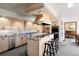 Open eat-in kitchen with stainless steel appliances, center island, bar seating, and bright cabinetry at 2851 Interlocken Dr, Evergreen, CO 80439