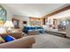 Spacious living room with comfortable seating, wood accents, and seamless transition into the dining area at 2851 Interlocken Dr, Evergreen, CO 80439