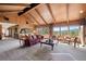 Spacious living room with wood paneling, vaulted ceilings, and scenic views from the expansive windows at 2851 Interlocken Dr, Evergreen, CO 80439