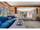 Comfortable living room with ample seating, large windows providing natural light, and an open layout to the dining room at 2851 Interlocken Dr, Evergreen, CO 80439