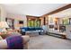 Open-concept living room featuring plush seating, exposed beams, and seamless flow to the dining area at 2851 Interlocken Dr, Evergreen, CO 80439
