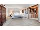 Spacious main bedroom featuring neutral tones, a large bed, and built in bookshelves, and abundant space at 2851 Interlocken Dr, Evergreen, CO 80439