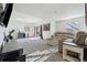 Bright, finished basement features a comfortable sitting area and sliding glass doors at 8086 S Grand Baker Way, Aurora, CO 80016