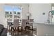 Bright dining room features a large window and seating for six at 8086 S Grand Baker Way, Aurora, CO 80016