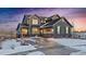 Charming two-story home with an attached garage and a picturesque snow-covered landscape at sunset at 8086 S Grand Baker Way, Aurora, CO 80016