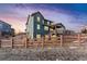 Two-story home with a deck, fenced backyard, and snowy landscape at 8086 S Grand Baker Way, Aurora, CO 80016