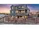 Two-story home with deck, fenced backyard, and stone accents at 8086 S Grand Baker Way, Aurora, CO 80016