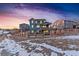 Two-story house, deck, fenced backyard, snowy landscape at 8086 S Grand Baker Way, Aurora, CO 80016